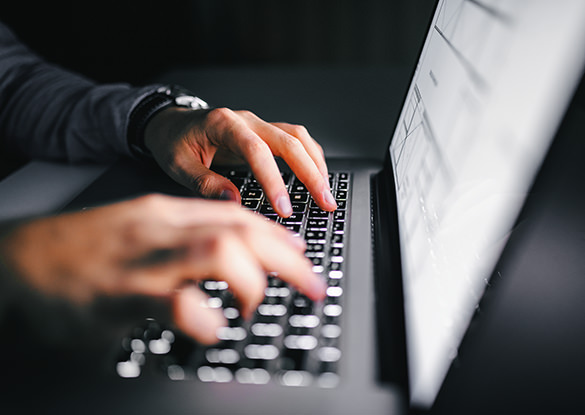 person typing on laptop keyboard